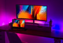 computer screens in purple and blue-lighted room - photo by Alexandru Acea on Unsplash