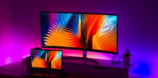 computer screens in purple and blue-lighted room - photo by Alexandru Acea on Unsplash