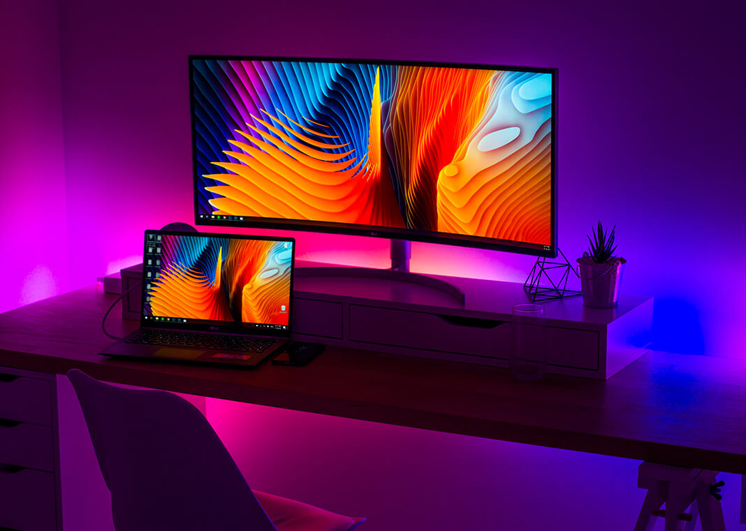 computer screens in purple and blue-lighted room - photo by Alexandru Acea on Unsplash