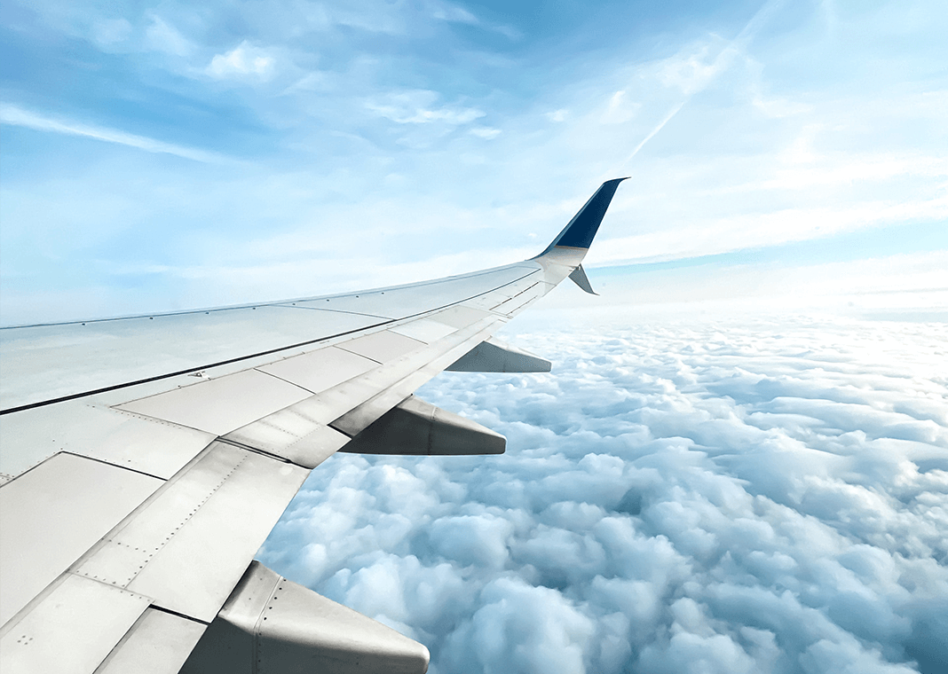 airplane in clouds - photo by Natali Quijano on Unsplash