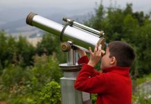 boy looking through telescope - Borislav Toskov/Shutterstock.com