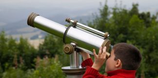 boy looking through telescope - Borislav Toskov/Shutterstock.com