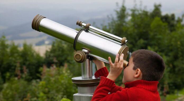 boy looking through telescope - Borislav Toskov/Shutterstock.com