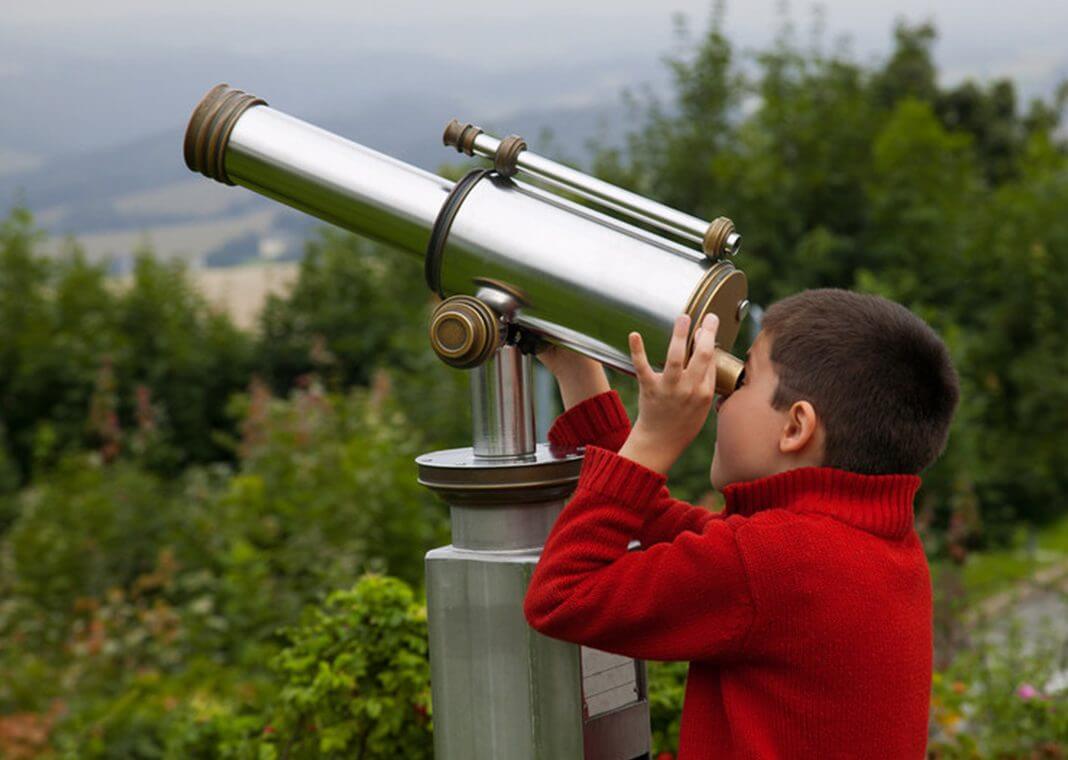 boy looking through telescope - Borislav Toskov/Shutterstock.com