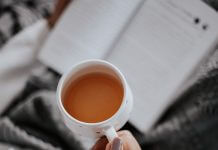 close-up of woman's teacup as she reads - photo by Farzad Mohamadi on Unsplash