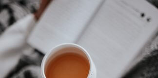 close-up of woman's teacup as she reads - photo by Farzad Mohamadi on Unsplash