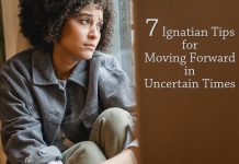 woman looking uncertainly out window - photo by Liza Summer from Pexels - text: 7 Ignatian Tips for Moving Forward in Uncertain Times