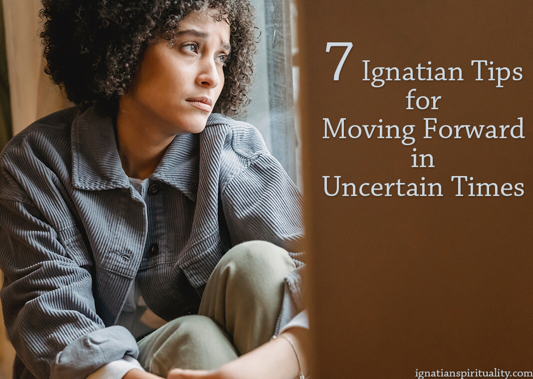 woman looking uncertainly out window - photo by Liza Summer from Pexels - text: 7 Ignatian Tips for Moving Forward in Uncertain Times