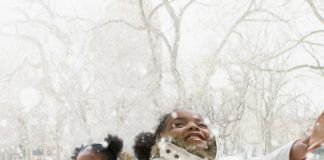 girls with arms open to catch snowflakes - photo by Jose Luis Pelaez Inc/Digital Vision/Getty Images