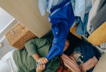 girl with messy stack of clothes - photo by Ketut Subiyanto from Pexels