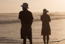 silhouette couple facing different directions on beach - photo by Daniel Joshua on Unsplash