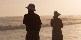 silhouette couple facing different directions on beach - photo by Daniel Joshua on Unsplash