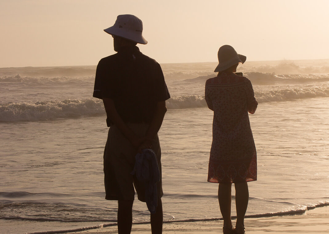 silhouette couple facing different directions on beach - photo by Daniel Joshua on Unsplash