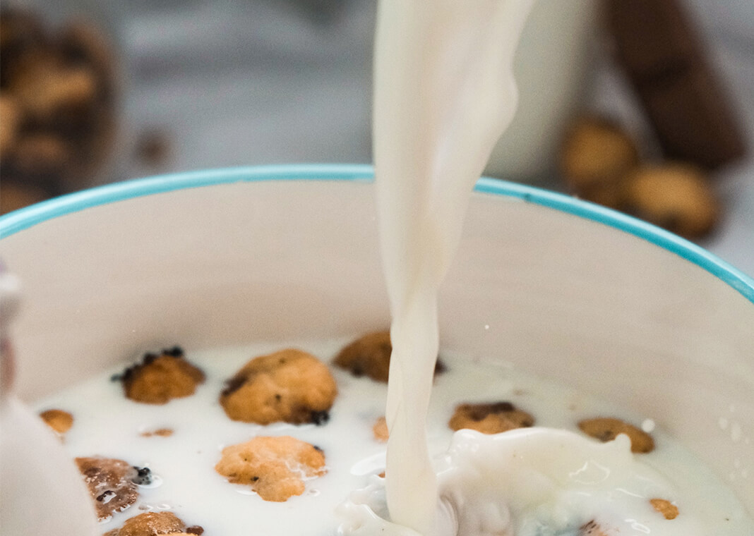 pouring milk in cereal bowl - photo by Mateusz D on Unsplash