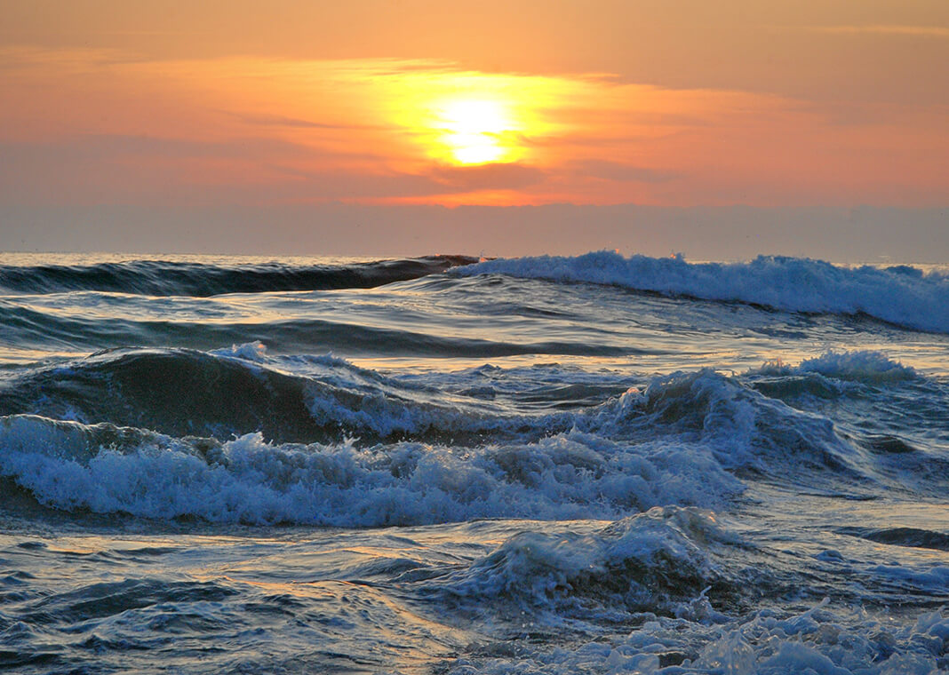 ocean waves at sunset - photo by Sascha Thiele on Pexels.com