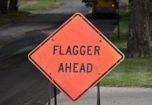 flagger ahead sign - image by OlinEJ from Pixabay