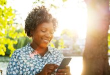 smiling woman with phone outside - Tim Robberts/Digital Vision/Getty Images