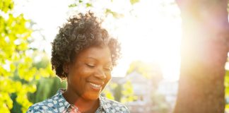 smiling woman with phone outside - Tim Robberts/Digital Vision/Getty Images