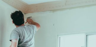 man painting wall - photo by Roselyn Tirado on Unsplash