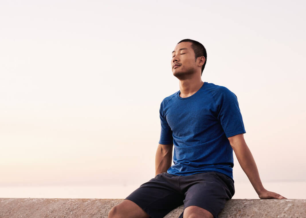 young man sitting at rest with eyes closed - mavo/Shutterstock.com