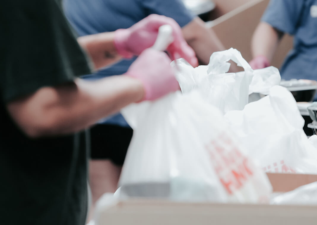 volunteers packing food - photo by Joel Muniz on Unsplash