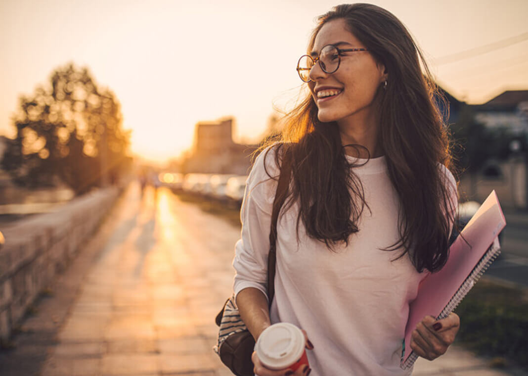 young woman looking to the side, as if she's in conversation with someone out of view - FluxFactory/E+/Getty Images