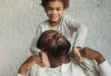 caring man looking up at son on shoulders - photo by Keira Burton on Pexels.com