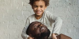 caring man looking up at son on shoulders - photo by Keira Burton on Pexels.com