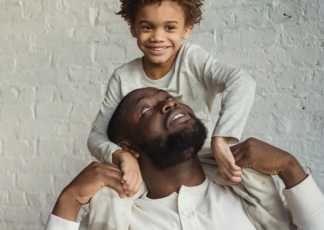 caring man looking up at son on shoulders - photo by Keira Burton on Pexels.com