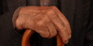 close-up of man's hand holding cane - photo by Kadir Polat on Pexels.com
