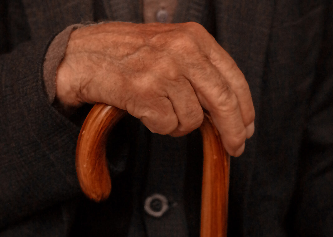close-up of man's hand holding cane - photo by Kadir Polat on Pexels.com