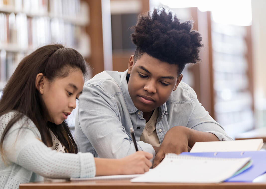 teen tutor works with elementary student / SDI Productions/E+/Getty Images