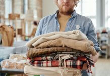 volunteer standing with armful of blankets - photo by Julia M. Cameron on Pexels