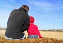 father and young child sitting outside, snuggled together - image by faithfinder06 from Pixabay