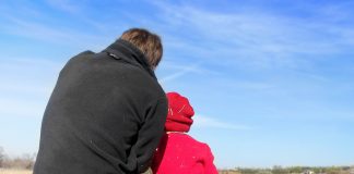 father and young child sitting outside, snuggled together - image by faithfinder06 from Pixabay