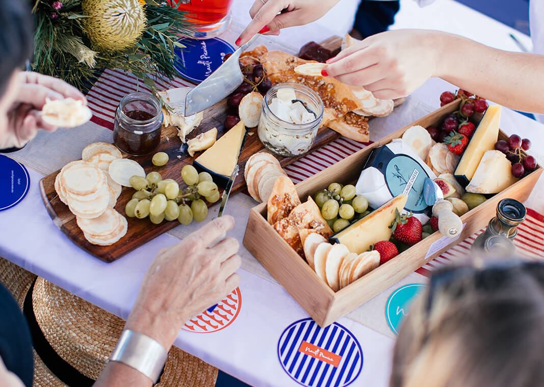 cheese and fruit on picnic table seen from above - photo by Rachel Claire via Pexels