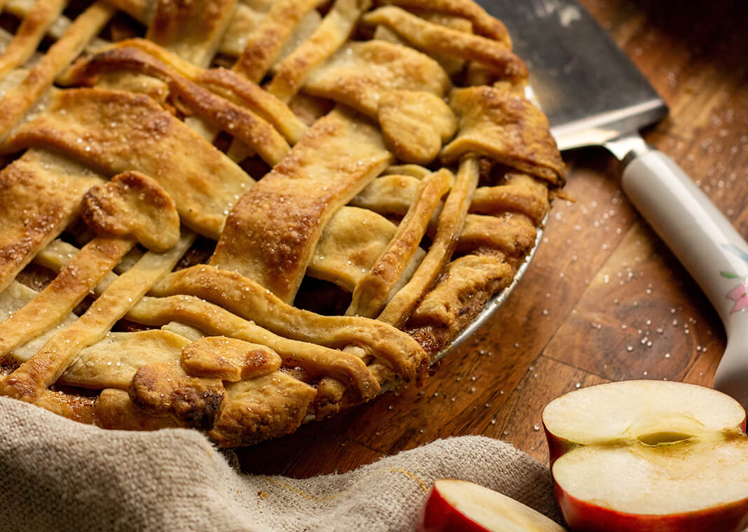 cut apple next to baked apple pie - photo by stephanie monfette on Unsplash