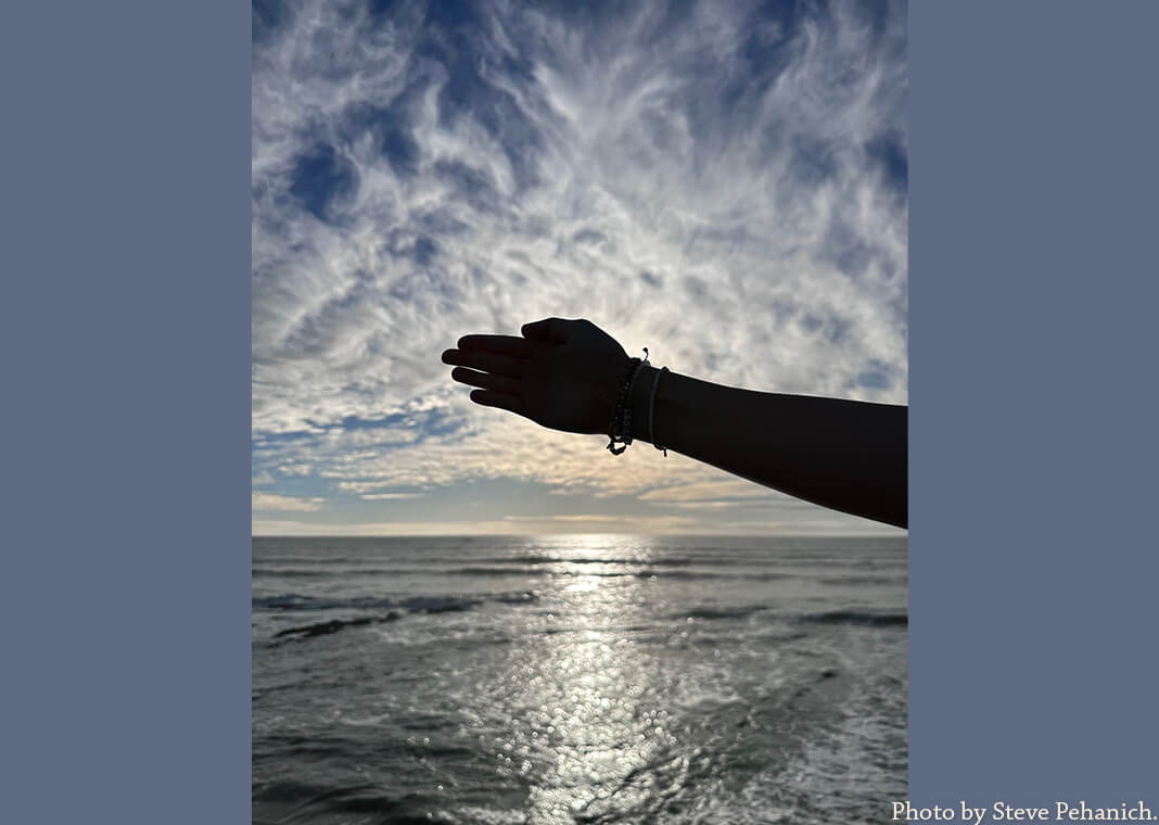 hand shielding sun over water - photo by Steve Pehanich