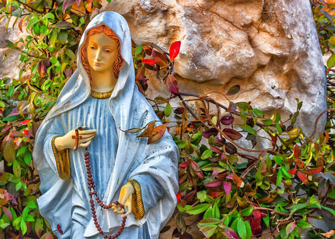 Mary statue with rosary in garden - (c) OnTheWind - VividaPhotoPC/iStock/Getty Images