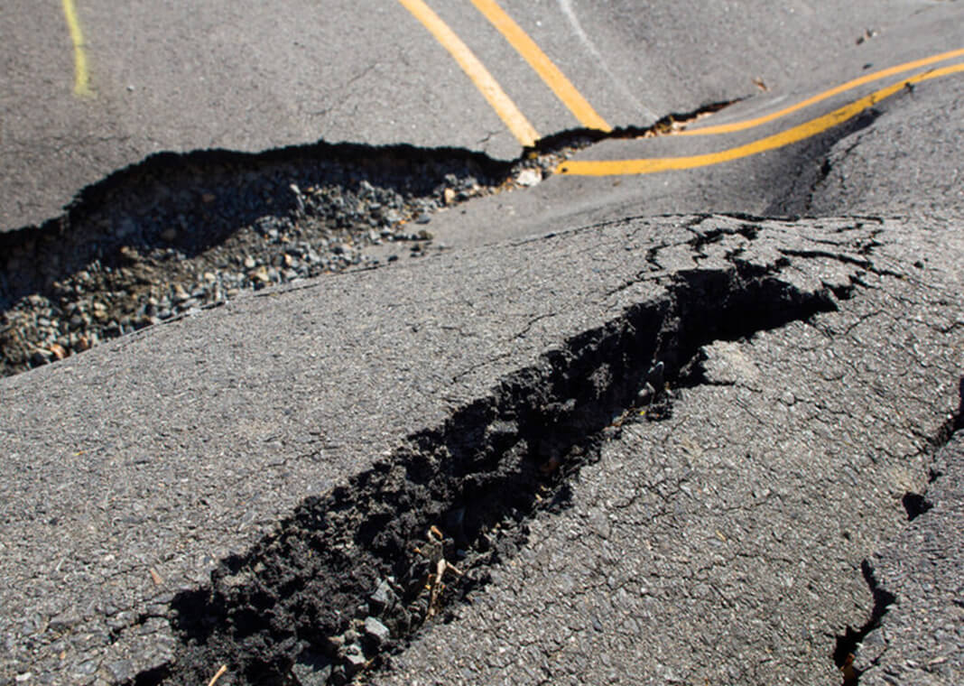 cracks in the road - IrinaK/Shutterstock.com