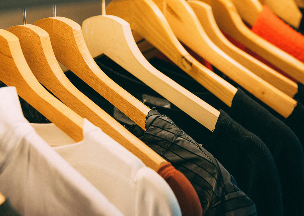 clothes on hangers in closet - photo by Kai Pilger on Unsplash