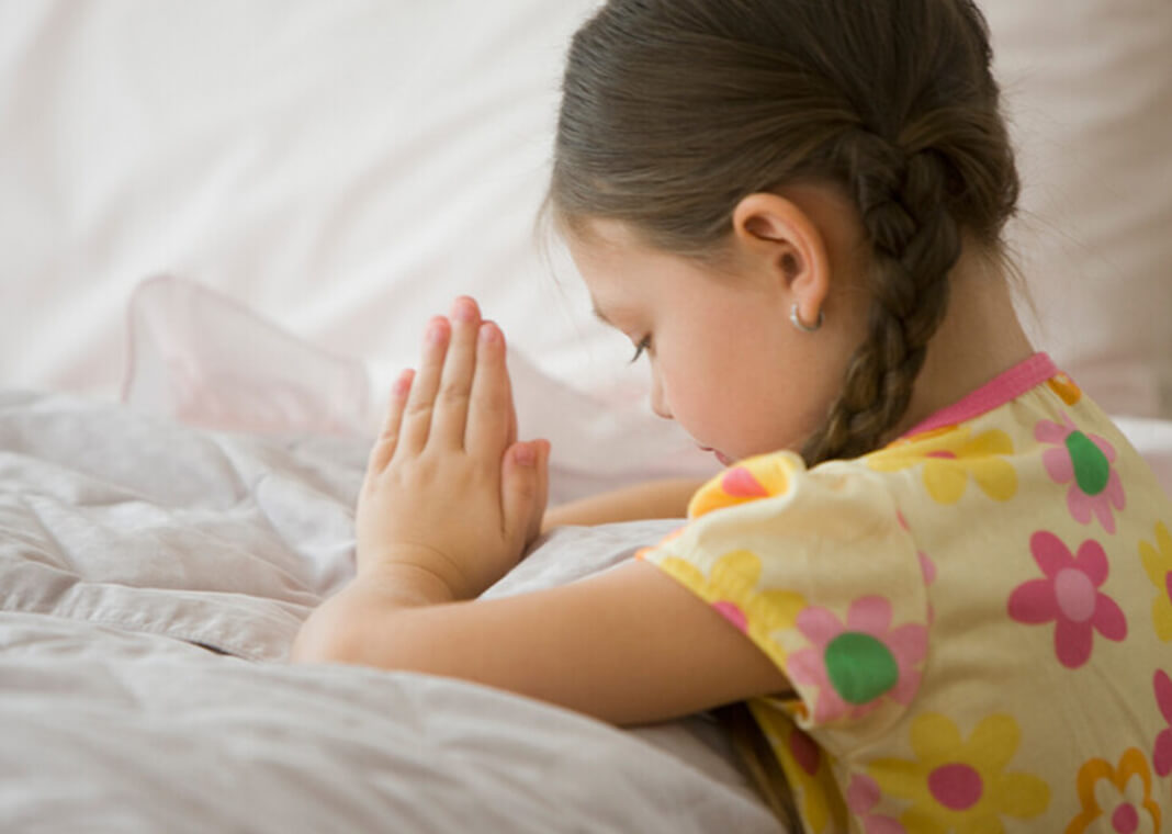 girl praying at bedside - Jose Luis Pelaez Inc/Digital Vision/Getty Images