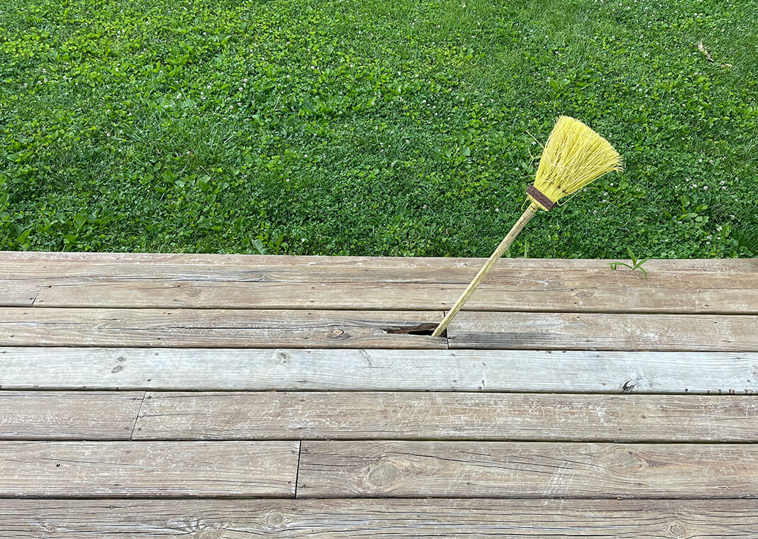 broom poking through deck, suggesting incomplete project - photo by Mark Stosberg on Unsplash