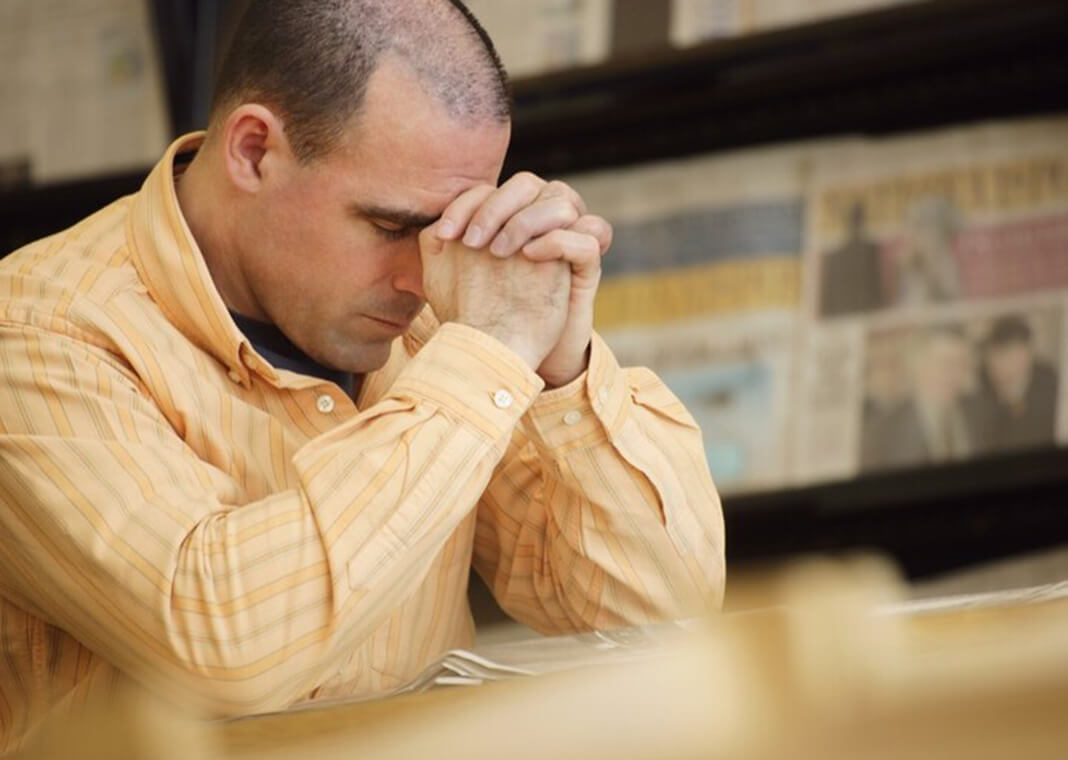 man praying - Vibe Images/Shutterstock.com