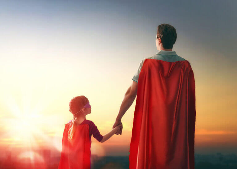 father and daughter in superhero capes - Choreograph/iStock/Getty Images