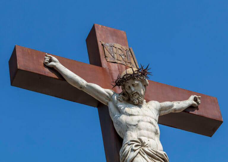 outdoor crucifix against a blue sky - Jekaterina Sahmanova/iStock/Getty Images