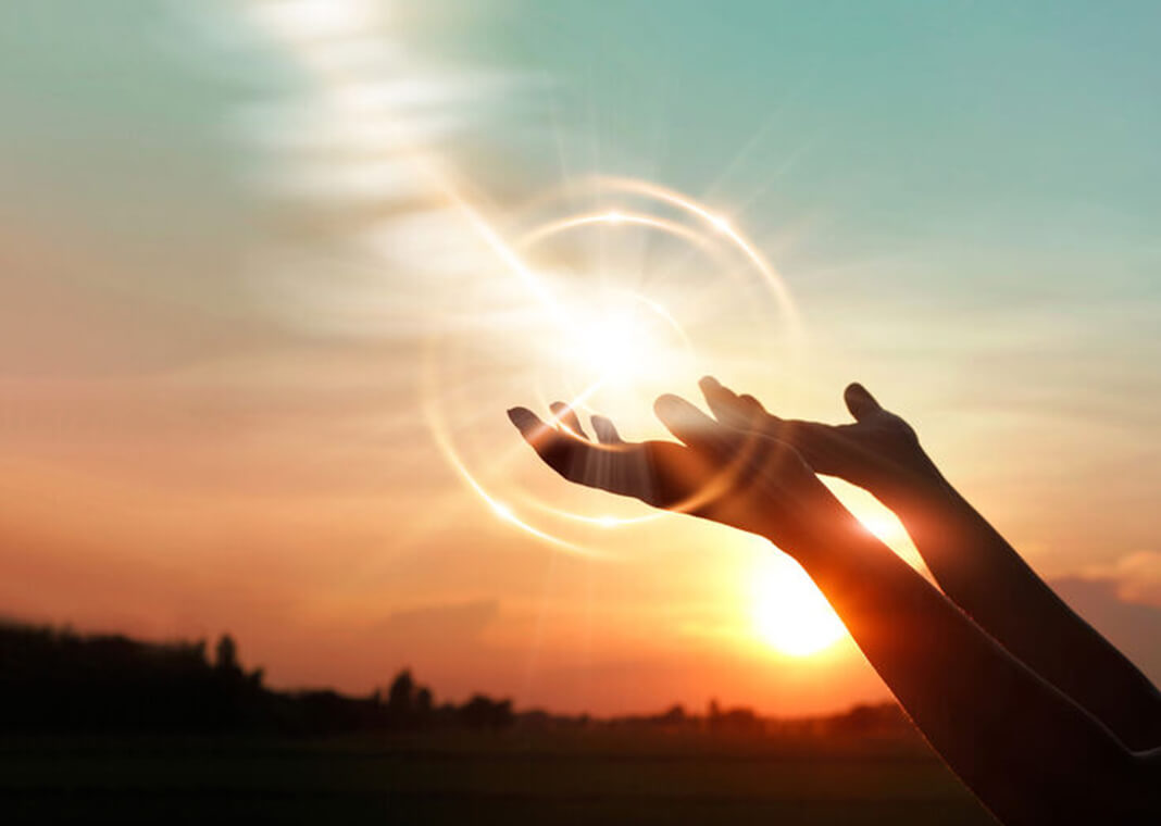 hands raised to sky in gesture of openness, forgiveness, or letting go - ipopba/iStock/Getty Images