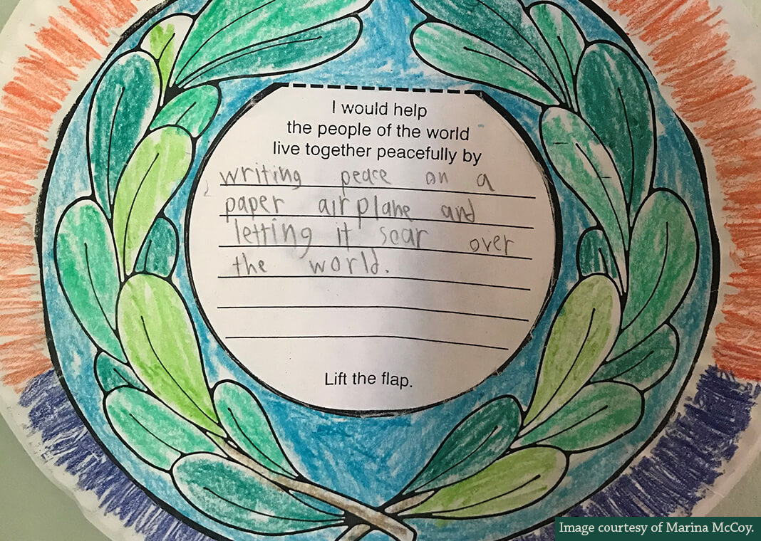 child's art project on peace with text, "writing peace on a paper airplane and letting it soar over the world" - image courtesy of Marina McCoy