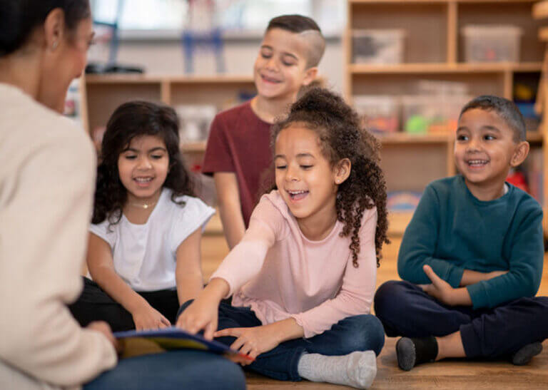 teacher reading with young students - FatCamera/E+/Getty Images