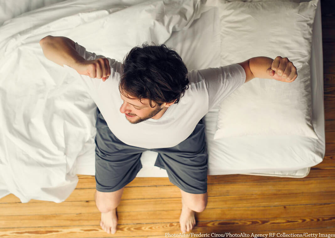 man stretching after waking up - PhotoAlto/Frederic Cirou/PhotoAlto Agency RF Collections/Getty Images